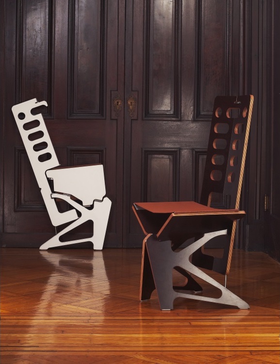 A folded white and open coffee Maya folding chairs